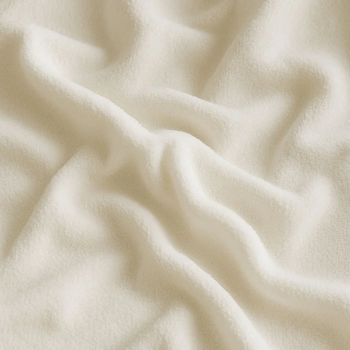 Close-up of a baby white mattress protector with soft texture