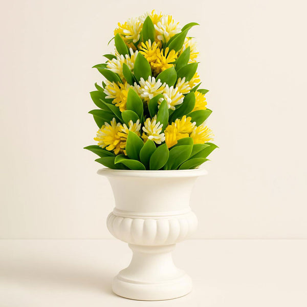 White urn with yellow flowers on a beige background