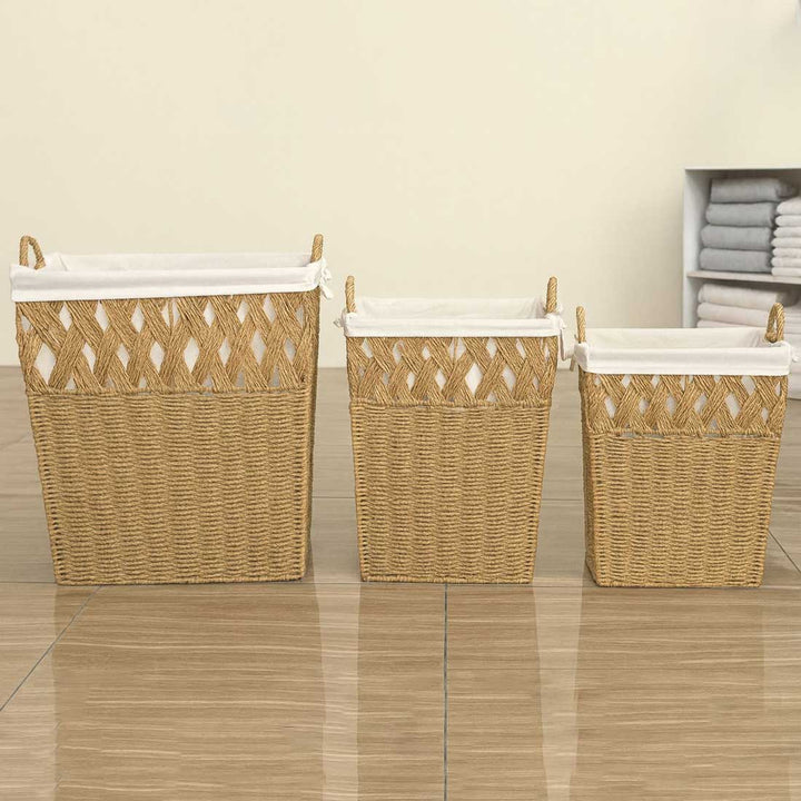 Three woven laundry baskets with white lids on a tiled floor.