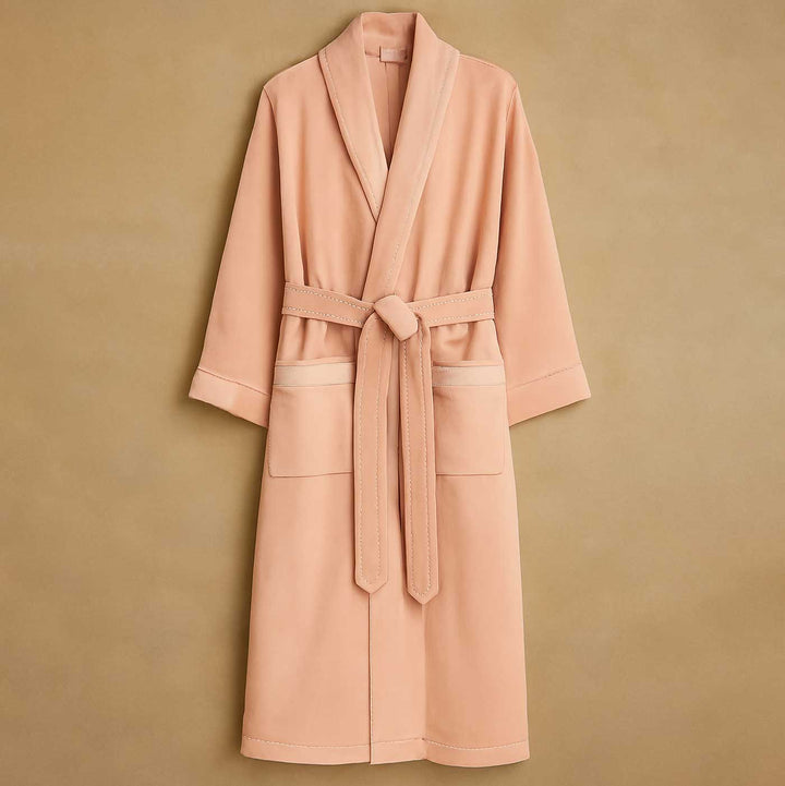 Pink robe with a belt on a beige background