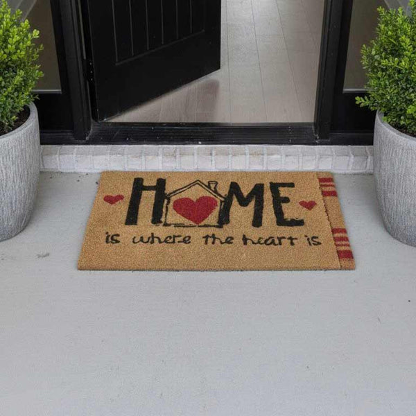 Doormat with 'Home is where the heart is' text on a porch