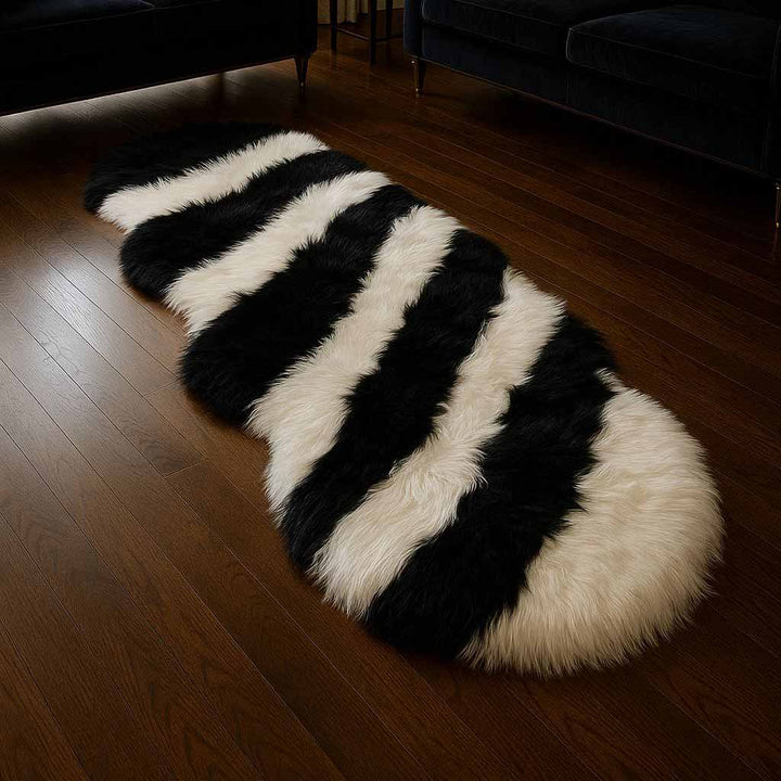 Black and white striped rug on a wooden floor