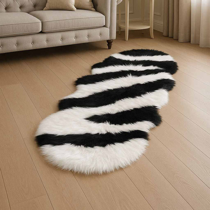 Black and white striped rug on a wooden floor in a living room setting.
