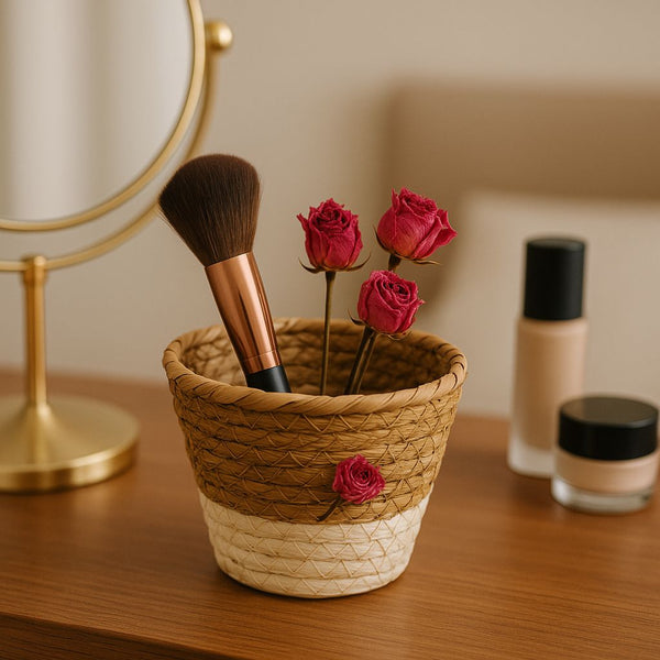 Woven basket with makeup brush and roses on a vanity table with cosmetic products.