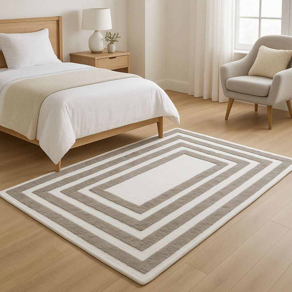 Bedroom with a striped rug, bed, nightstand, and chair.