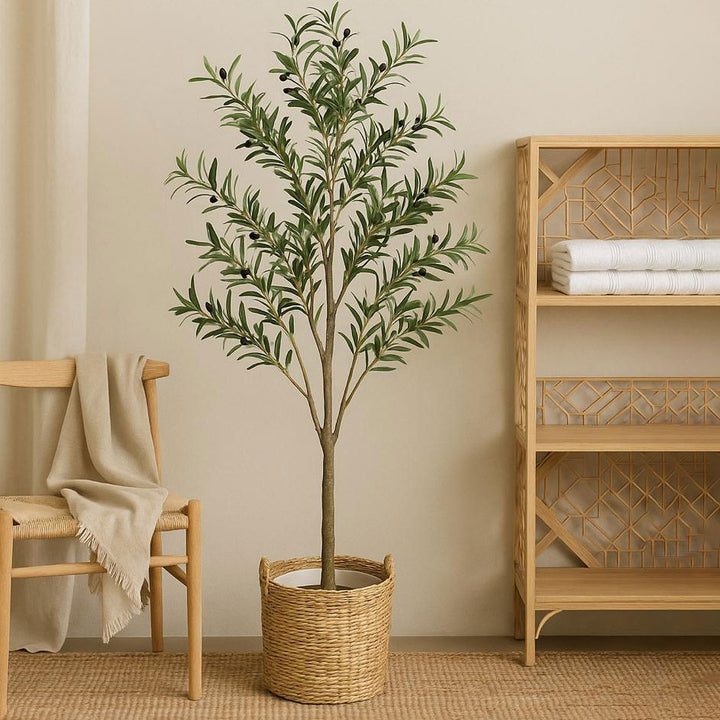 Artificial potted plant in a room with a wooden chair and shelf.