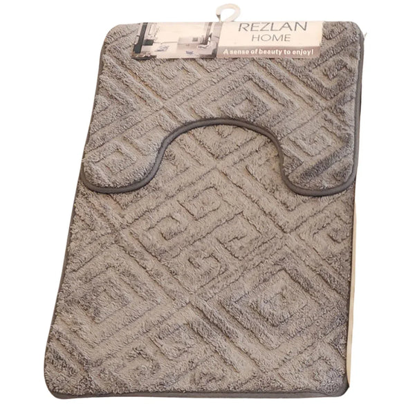 Gray textured bath mat with geometric pattern on a white background, featuring 'Rezlan Home' branding.