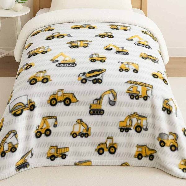 Blanket with construction vehicle pattern on a chair