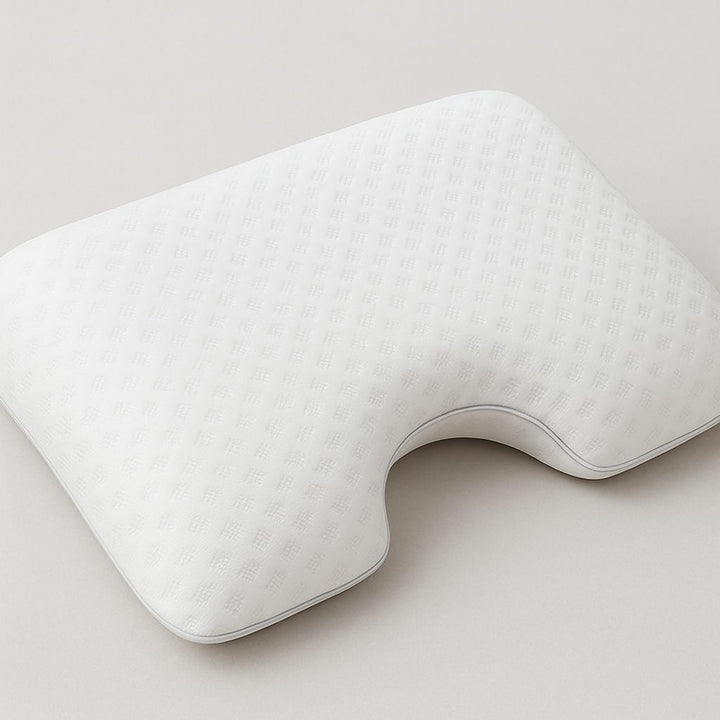 White U-shaped pillow on a light gray background