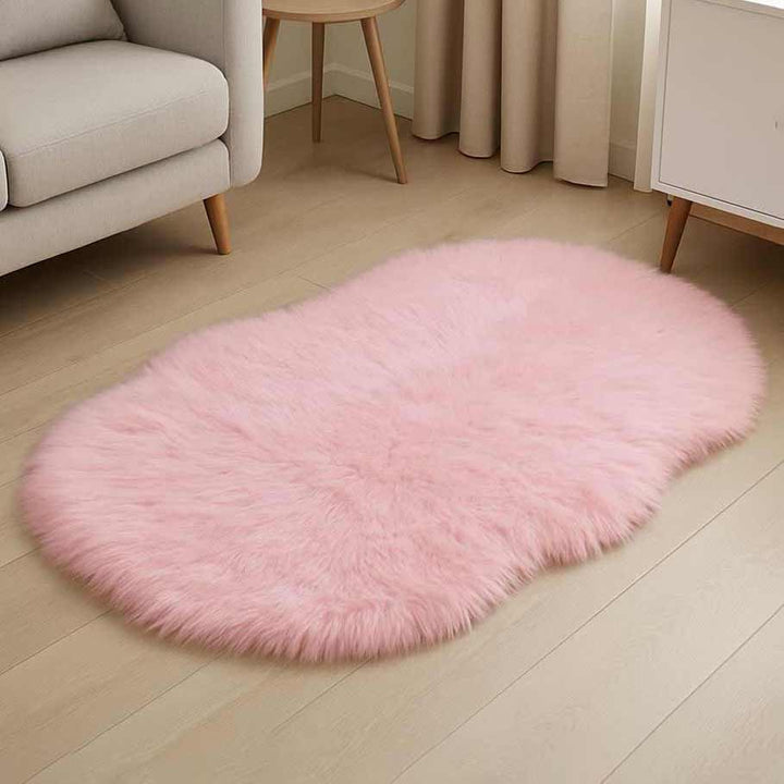 Pink fluffy rug on a wooden floor in a living room setting.