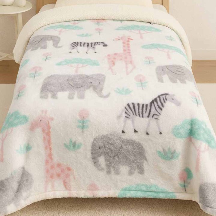 Flannel blanket with animal pattern on a bed