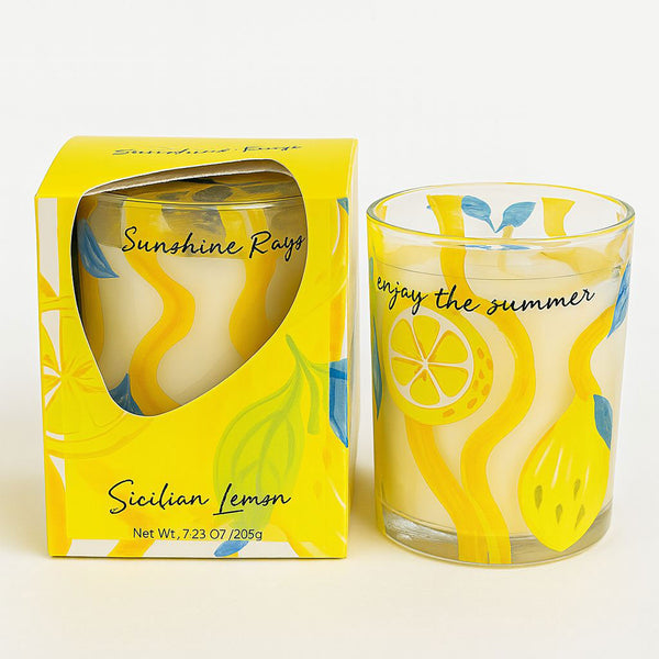 Scented candle with lemon design and packaging on a white background