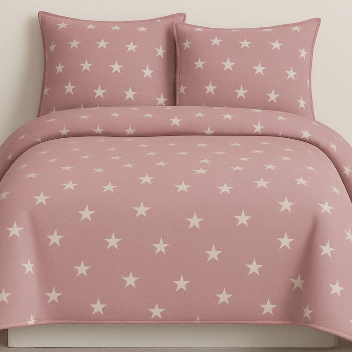 Pink star-patterned bedding set on a plain background