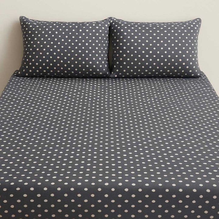 Polka dot bed sheet set on a plain background