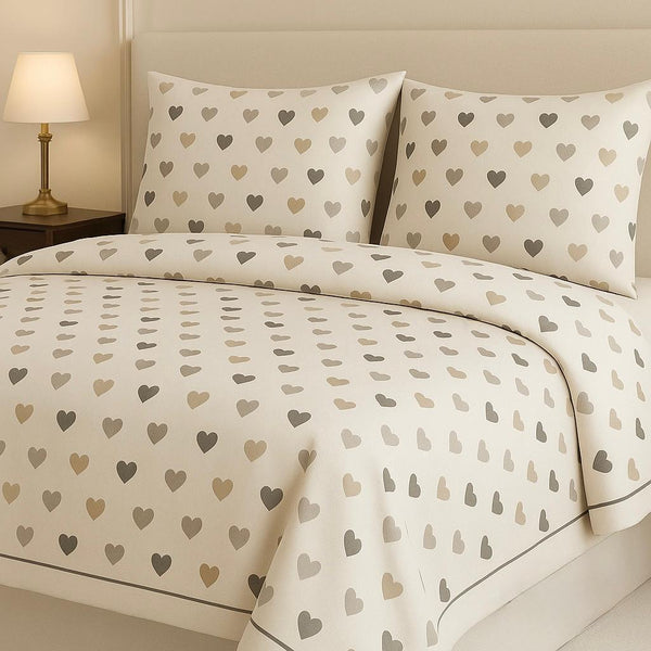 Heart-patterned bedding set on a bed with matching pillows, in a bedroom setting.