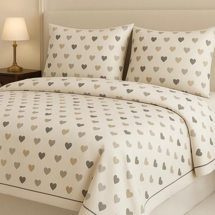 Heart-patterned bedding set on a bed with matching pillows, in a bedroom setting.