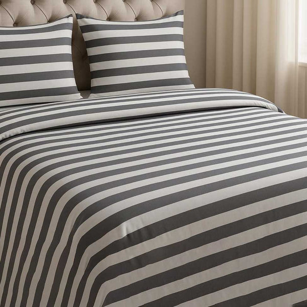Striped duvet cover set with matching pillows on a bed in a bedroom setting.