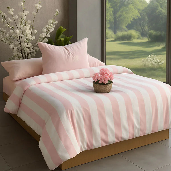 Pink and white striped bedding set on a bed with a window view of greenery.