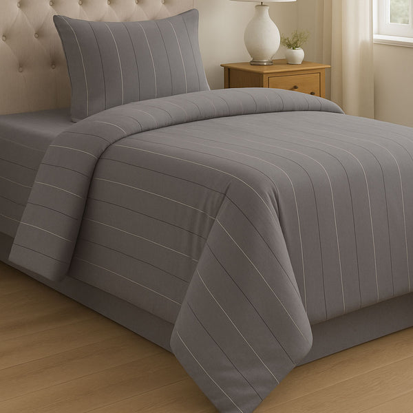 Gray striped bedding set on a bed in a bedroom setting.
