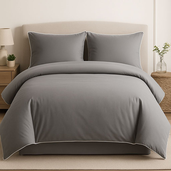 Gray bedding set on a bed in a bedroom setting