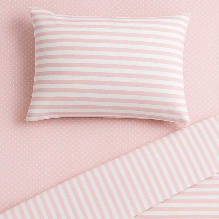Striped pillow and bedding on a pink background