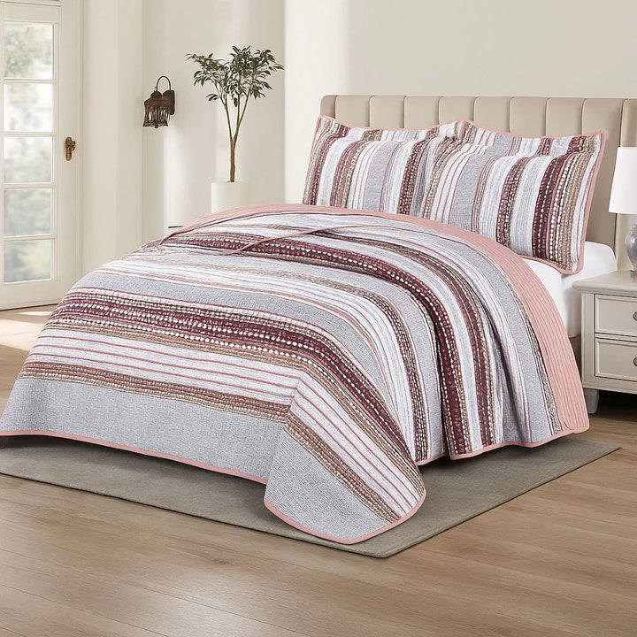 Striped bedspread set on a bed in a bedroom setting