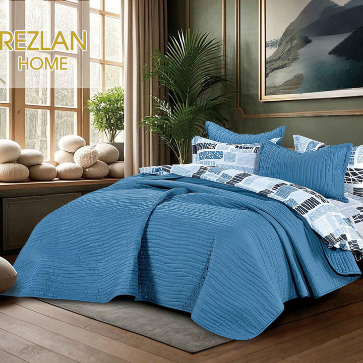 Summer blue bedspread set with quilted wavy lines pattern, styled on a made bed