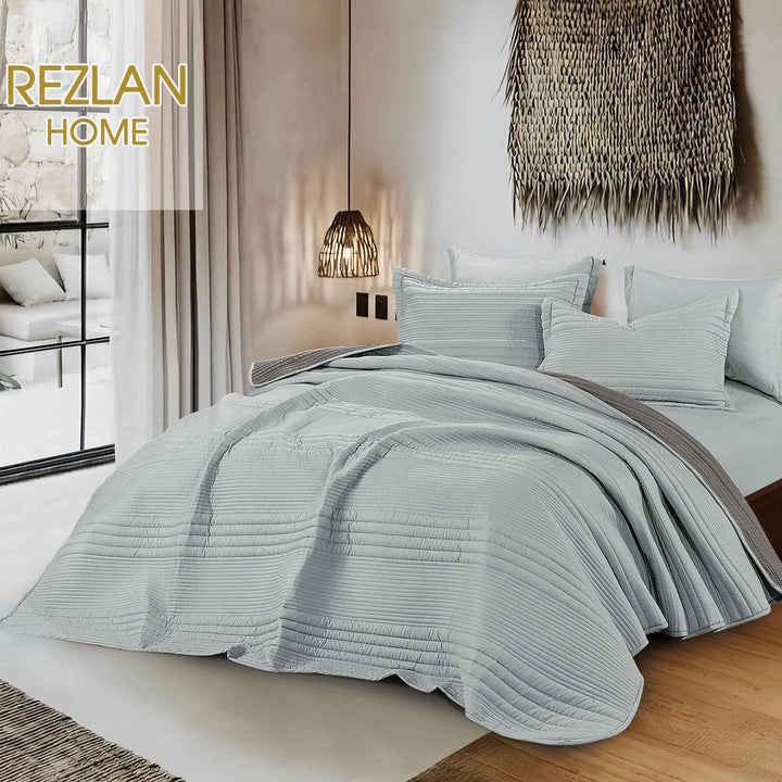 Summer gray bedspread set with quilted stripes pattern, styled on a made bed