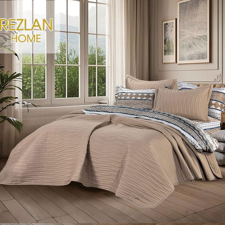 Summer greige bedspread set with quilted wavy lines pattern, styled on a made bed
