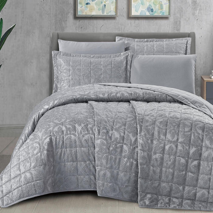 Summer gray bridal bedspread set with a quilted fleur-des-lis pattern, styled on a king size bed