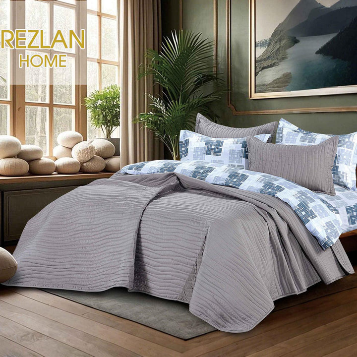 Summer gray bedspread set with quilted wavy lines pattern, styled on a made bed