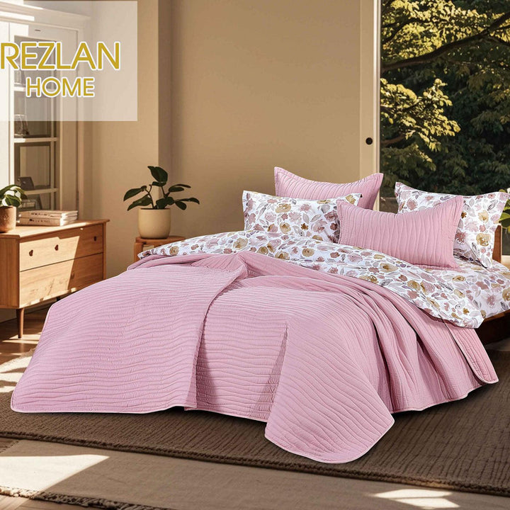 Summer light pink bedspread set with quilted wavy lines pattern, styled on a made bed