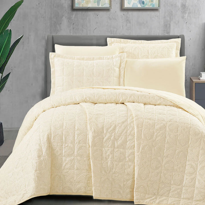 Summer off-white bridal bedspread set with a quilted fleur-des-lis pattern, styled on a king size bed