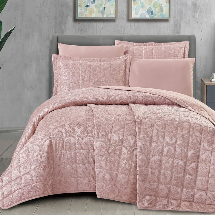 Summer pink bridal bedspread set with a quilted fleur-des-lis pattern, styled on a king size bed