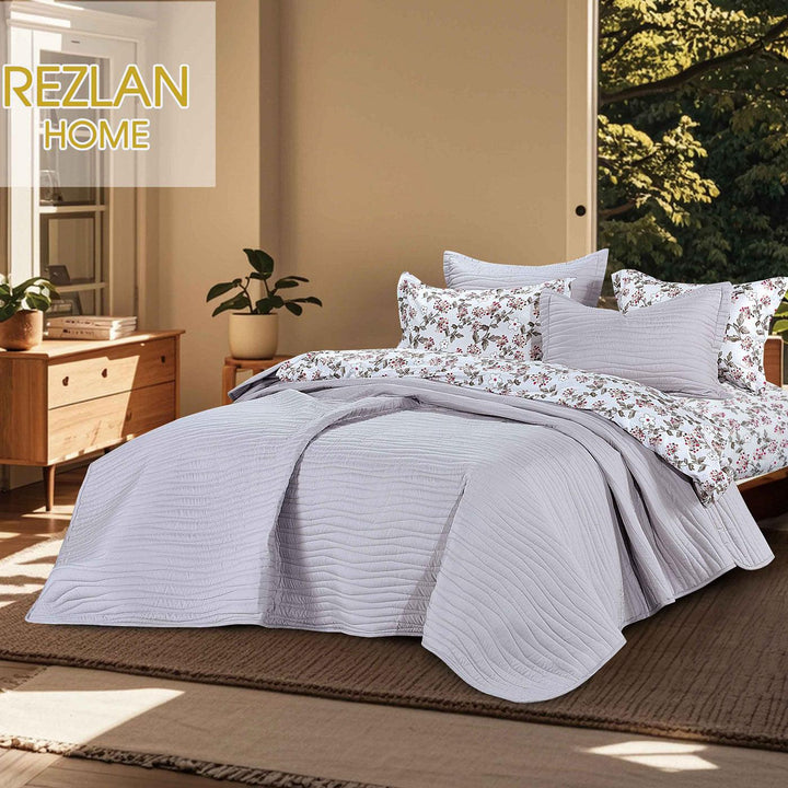 Summer silver gray bedspread set with quilted wavy lines pattern, styled on a made bed