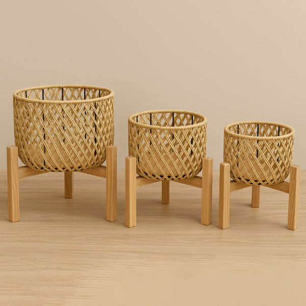 Three woven baskets on wooden stands against a beige background