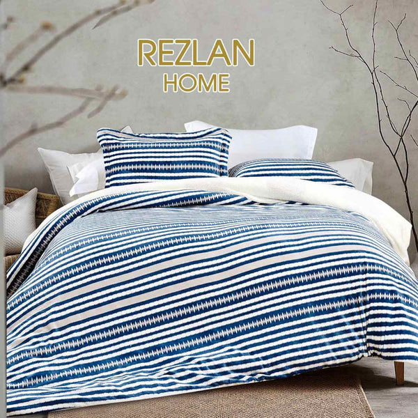 Bed with blue and white striped bedding in a room with branches on the wall, featuring the brand 'Rezlan Home'.