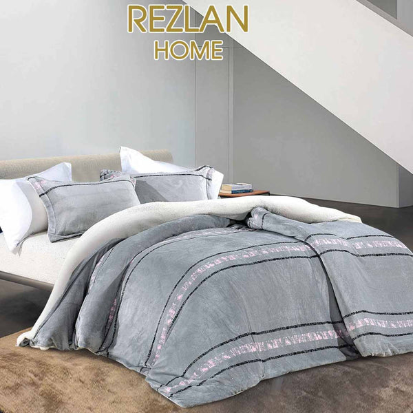 Gray textured comforter on a bed with 'REZLAN HOME' branding.