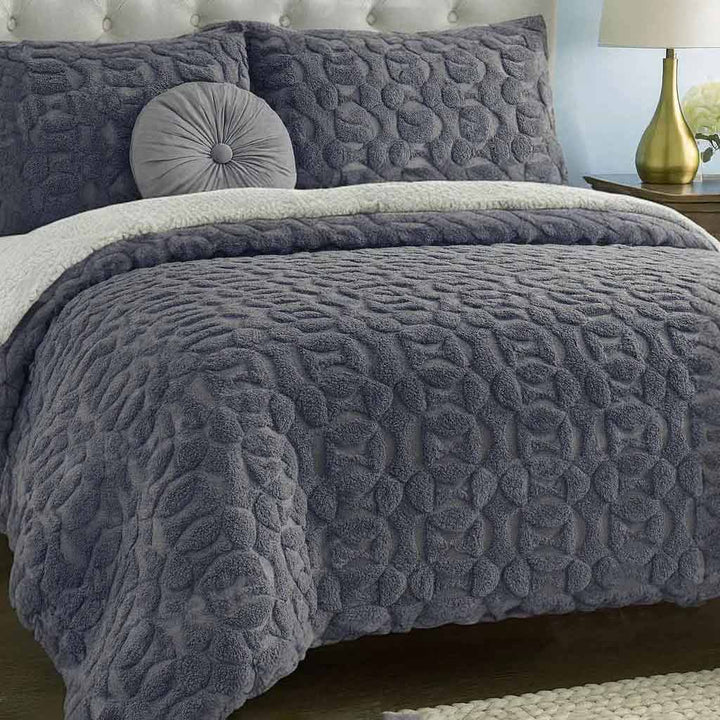 Textured gray duvet cover set on a bed with matching pillows in a bedroom setting.