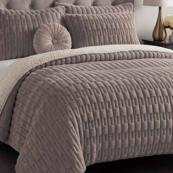 Textured brown bedding set on a bed with matching pillows.